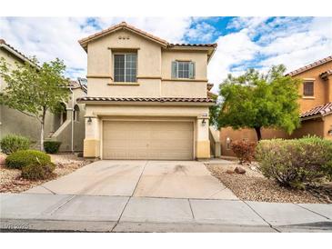 Charming two-story home featuring a two-car garage, desert landscaping, and neutral stucco exterior at 9750 Maple Sugar Leaf Pl, Las Vegas, NV 89148