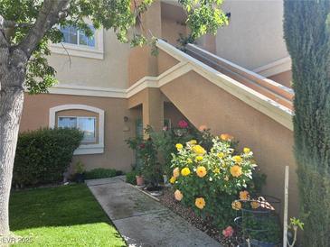 Charming condo featuring a landscaped entrance with vibrant flowers and a well-maintained walkway at 10500 Pine Pointe Ave # 206, Las Vegas, NV 89144