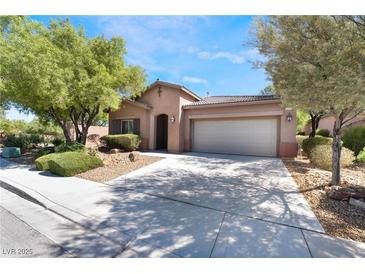 Charming single-story home featuring a well-manicured yard and attached two-car garage at 10858 Morning Frost St, Las Vegas, NV 89179