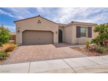 Charming single-story home with a brick driveway, a two-car garage, and desert landscaping at 1108 Via Della Curia, Henderson, NV 89011