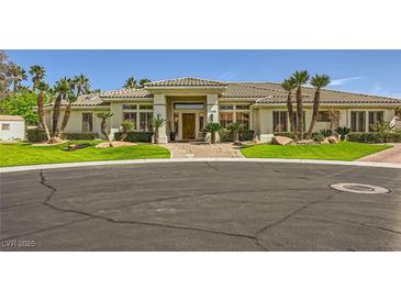 Well-maintained home with lush landscaping, mature palm trees, and circular driveway at 1508 Ten Palms Ct, Las Vegas, NV 89117