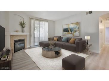 Bright living room featuring a fireplace, neutral paint, and sliding glass door for outdoor access at 1830 N Buffalo Dr # 1091, Las Vegas, NV 89128