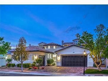 Charming stucco home with a tile roof, two-car garage, manicured landscaping, and beautiful curb appeal at 3020 Via Venezia, Henderson, NV 89052
