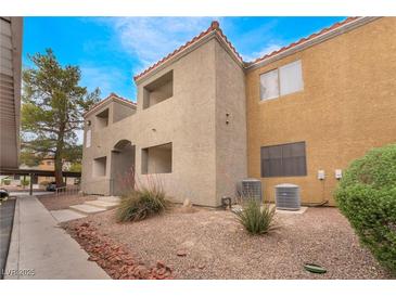 A two-story home features stucco exterior, red tile roof, and low-maintenance landscaping at 3151 Soaring Gulls Dr # 2034, Las Vegas, NV 89128