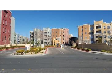 Manhattan Condominiums community entrance with colorful buildings, manicured landscaping, and well maintained driveways at 50 E Serene Ave # 321, Las Vegas, NV 89123