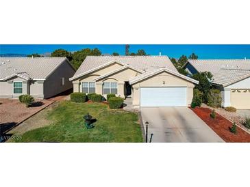 Charming single story home with a manicured lawn and two car garage at 5508 Lochmor Ave, Las Vegas, NV 89130