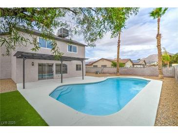 Backyard pool area with a covered patio, perfect for outdoor entertaining and relaxation at 5629 Caladonia Ave, Las Vegas, NV 89110