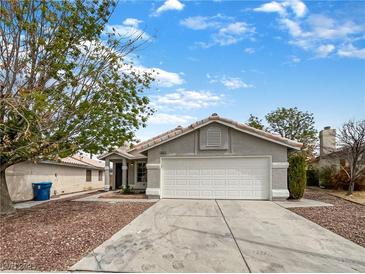Charming single-story home featuring a two-car garage, neutral paint, and desert landscaping for easy maintenance at 6412 Dallaswood Ln, Las Vegas, NV 89156