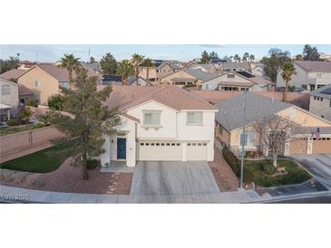 Charming two-story home with a three car garage and a low maintenance yard at 810 Roaring Falls Ave, Henderson, NV 89052