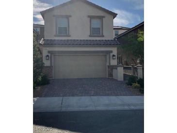 Charming two-story home with a brick driveway and a two-car garage at 8111 Switchback Run St, Las Vegas, NV 89166