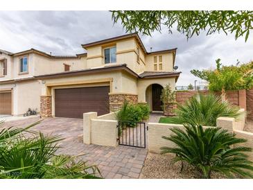 Charming two-story home featuring desert landscaping, a two-car garage, and a gated front entry in a suburban neighborhood at 1417 Brushback Ave, Henderson, NV 89074