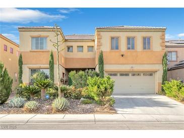 Charming two-story home featuring a two-car garage and desert landscaping at 1604 Danielle Rebecca Ave, North Las Vegas, NV 89086