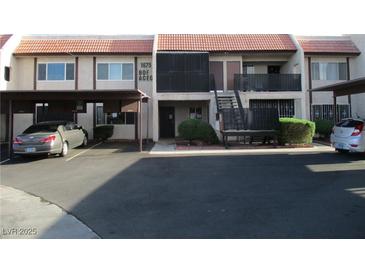 Townhouse featuring a covered carport and a red tile roof in a well-maintained complex at 1675 Jupiter Ct # C, Las Vegas, NV 89119