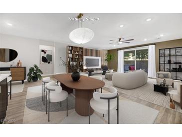 Spacious living room featuring modern furniture and a large sliding glass door at 234 Polaris Ridge Ave, Henderson, NV 89011