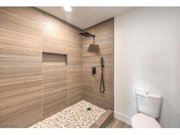 Modern bathroom featuring a tiled shower with a rainfall showerhead and built-in niche at 2606 S Durango Dr # 117, Las Vegas, NV 89117