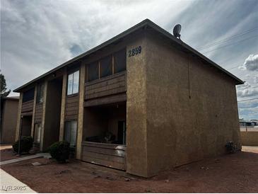 Two story tan building with second story balconies and dark trim and landscaping at 2859 Wheelwright Dr, Las Vegas, NV 89121