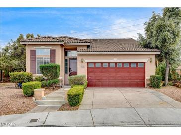 Charming single-story home featuring a tile roof, manicured landscaping, and a two-car garage at 3200 Ridgecliff St, Las Vegas, NV 89129