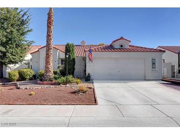 Charming single-story home with a tile roof, low-maintenance landscaping, and an attached two-car garage at 3913 Cutting Horse Ave, North Las Vegas, NV 89032