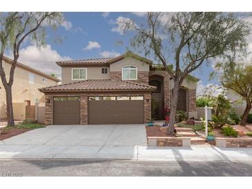 Charming two-story home with a three car garage, tile roof, and beautifully landscaped front yard at 5404 Ireland St, Las Vegas, NV 89149