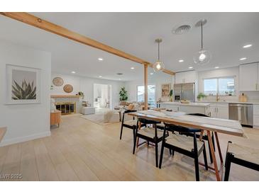 Bright and airy living room showcasing a fireplace and dining area that leads to a modern kitchen at 5904 Apple Valley Ln, Las Vegas, NV 89108