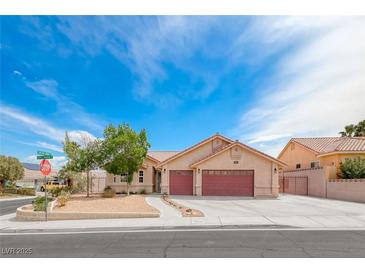 Charming single-story home with a well-manicured front yard and a three-car garage in a quiet neighborhood at 902 Little Raven St, Henderson, NV 89002