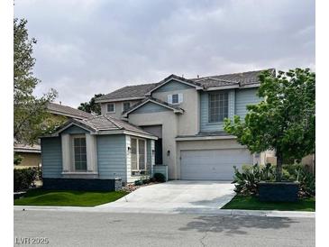 Charming two-story home featuring a two-car garage, landscaped yard, and classic suburban appeal at 10381 Walking View Ct, Las Vegas, NV 89135