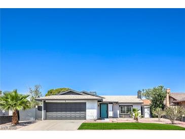 Charming single-story home featuring a well-maintained front yard and a gray two-car garage door at 4012 Mira Ln, Las Vegas, NV 89108