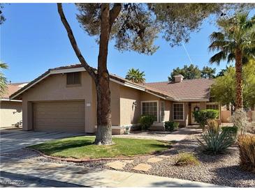 Charming single-story home featuring a two-car garage and nicely landscaped front yard at 2022 Big Bend Way, Henderson, NV 89074