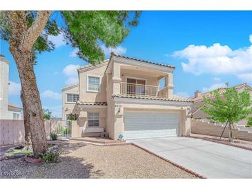 Charming two-story home featuring a balcony, two-car garage, and landscaped front yard at 6536 Castor Tree Way, Las Vegas, NV 89108