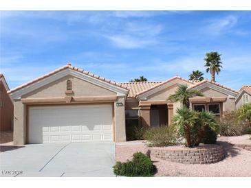 Charming single-story home with a well-manicured front yard and a two-car garage at 10732 Cedar Creek Ave, Las Vegas, NV 89134