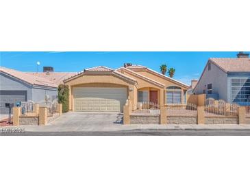 Charming single-story home with a two-car garage, low-maintenance landscaping, and a gated front yard at 1437 Daybreak Dr, Las Vegas, NV 89108