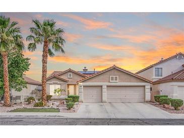 Charming single-story home featuring a well-maintained lawn, mature trees, and a spacious three-car garage at 1552 Livingston Dr, Henderson, NV 89012