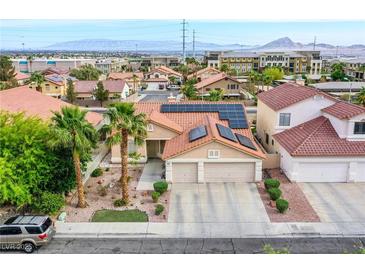 Charming single-Gathering home with a well-manicured front yard, palm trees, and solar panels in a residential neighborhood at 1552 Livingston Dr, Henderson, NV 89012