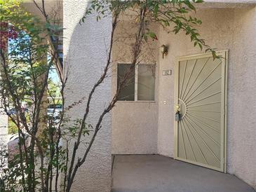 Inviting entryway with a decorative front door and textured stucco exterior for a secure and stylish entrance at 2117 Echo Bay St # 102, Las Vegas, NV 89128