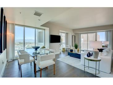 Bright living and dining area features floor-to-ceiling windows and stylish, contemporary furnishings at 2700 Las Vegas Blvd # 2303, Las Vegas, NV 89109
