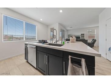 Modern kitchen island features a stainless steel dishwasher, sink, and a bright window with scenic views at 31 Strada Loreto, Henderson, NV 89011