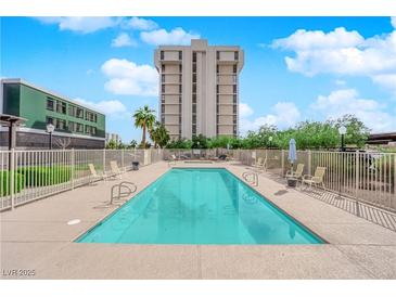 Outdoor pool with lounge chairs and desert landscaping, in front of high rise building at 3930 University Center Dr # 202, Las Vegas, NV 89119