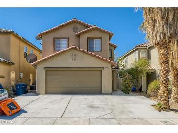 Two-story home featuring a red tile roof, spacious garage, and desert landscaping in a sunny setting at 4135 Pistachio Nut Ave, Las Vegas, NV 89115