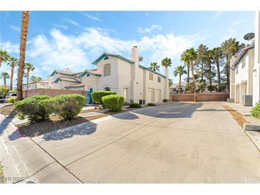 Inviting two-story exterior with well-maintained landscaping, a terracotta-colored roof and a long driveway at 5025 Starfinder Ave, Las Vegas, NV 89108