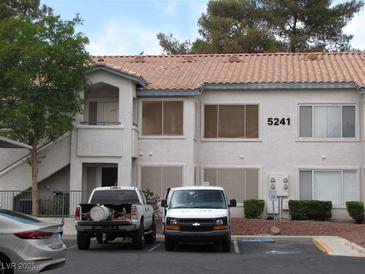Inviting condo features a red tile roof, two stories, ample parking, and a stucco facade at 5241 Caspian Springs Dr # 103, Las Vegas, NV 89120