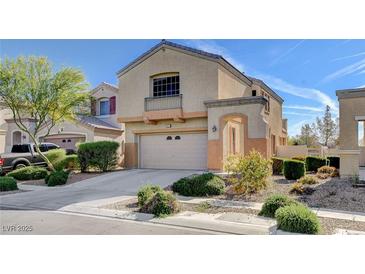 Inviting two-story home featuring a two-car garage, balcony and desert landscaping at 5524 Overlook Valley St, North Las Vegas, NV 89081