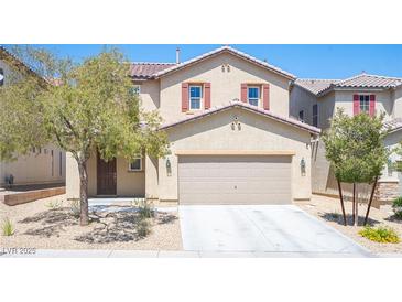 Two-story home with a two-car garage, desert landscaping and inviting front entrance at 5638 Jelsma Ave, Las Vegas, NV 89141