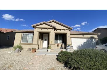 Inviting single story home with stucco facade, barrel accents, desert landscaping, and covered entry at 5832 Elphin Ct, North Las Vegas, NV 89031