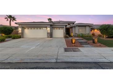 Attractive single-story home featuring a spacious three-car garage and manicured landscaping at 616 Canyon Brook Pl, Las Vegas, NV 89145