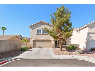 Charming two-story home with a well-manicured front yard and attached two-car garage at 672 Peach Coral St, Las Vegas, NV 89183