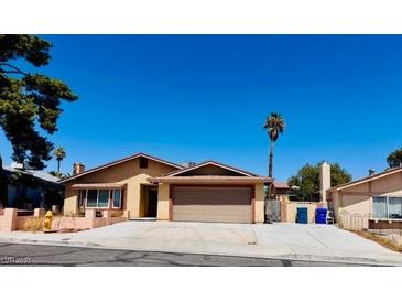 Charming single-story home with a well-maintained front yard and a two-car garage and desert landscaping at 6786 Grandola Dr, Las Vegas, NV 89103