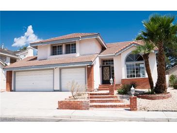 Charming two-story home featuring a two-car garage, tile roof, and well-maintained landscaping at 9704 Falling Star Ave, Las Vegas, NV 89117