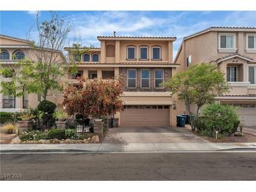 Charming stucco home featuring stone accents, manicured landscaping, and a two-car garage at 1161 Sax Fifth Ave, Henderson, NV 89052