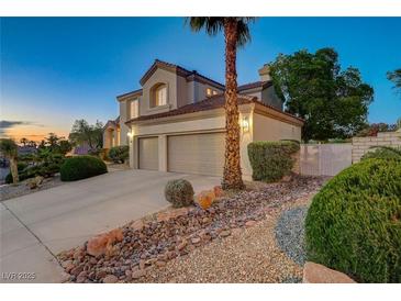 Beautiful two-story home with a two-car garage, desert landscaping, and a well-manicured lawn at 150 Wentworth Dr, Henderson, NV 89074