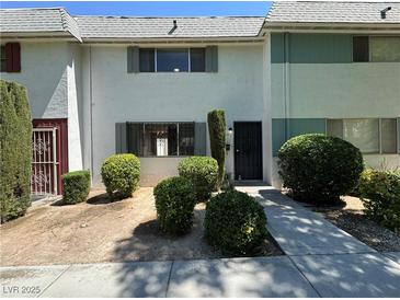 Charming townhouse with low-maintenance landscaping and neutral exterior paint at 173 Greenbriar Townhouse Way, Las Vegas, NV 89121